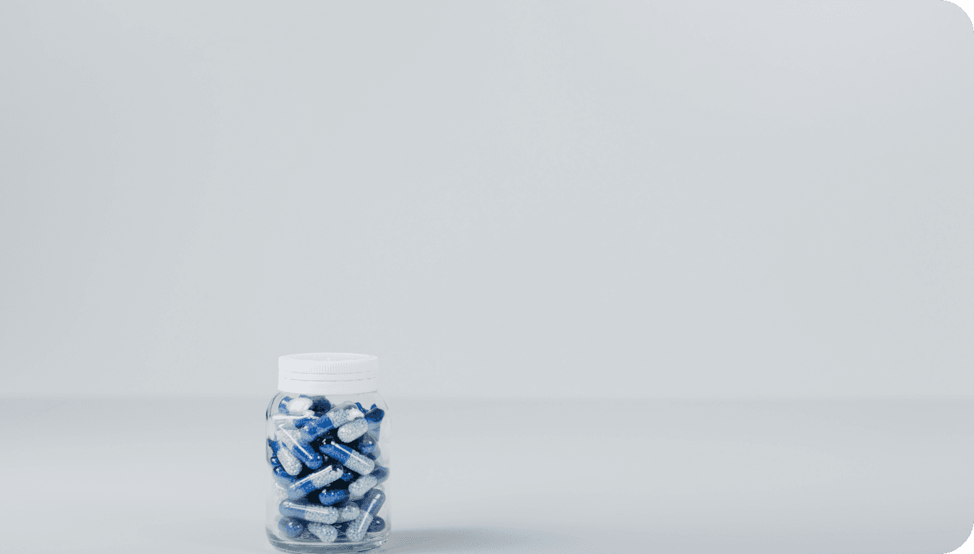 Bottle of bue pills on a white background